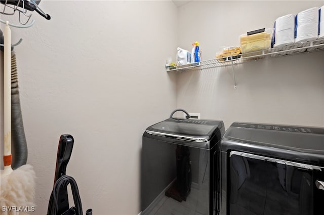 clothes washing area with independent washer and dryer