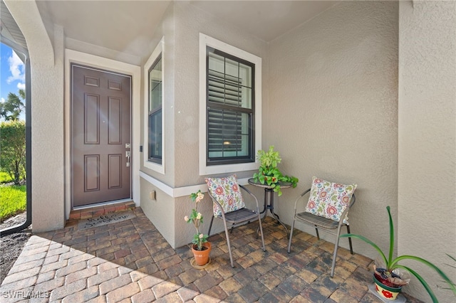 view of exterior entry with covered porch