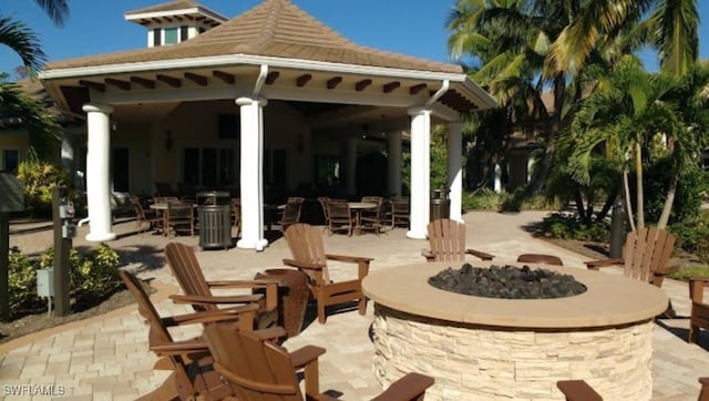 view of patio with a fire pit and a gazebo