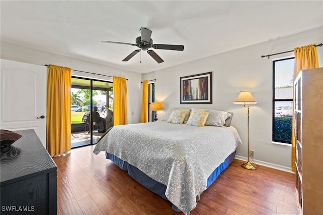 bedroom featuring access to exterior, ceiling fan, and dark wood-type flooring