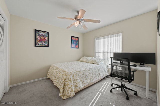 carpeted bedroom featuring ceiling fan and a closet