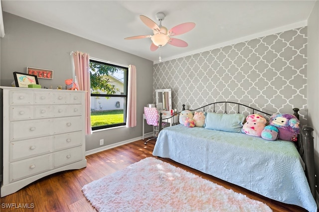 bedroom with ceiling fan and wood-type flooring