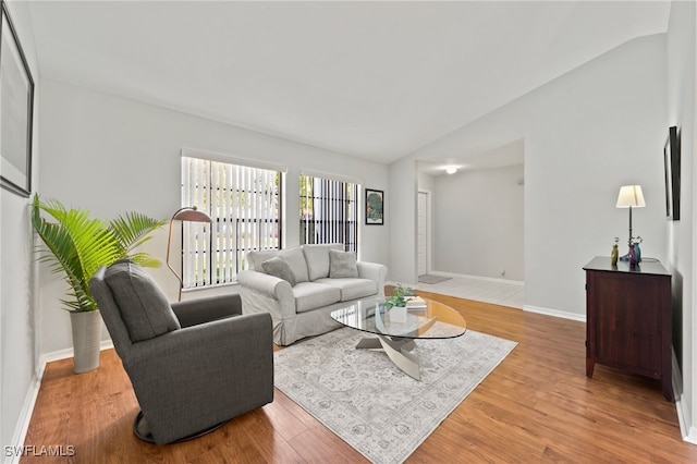 living room with hardwood / wood-style flooring and vaulted ceiling