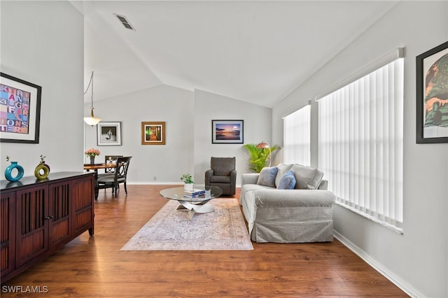 living room with wood-type flooring and vaulted ceiling