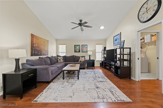 living room featuring dark hardwood / wood-style floors, ceiling fan, and vaulted ceiling