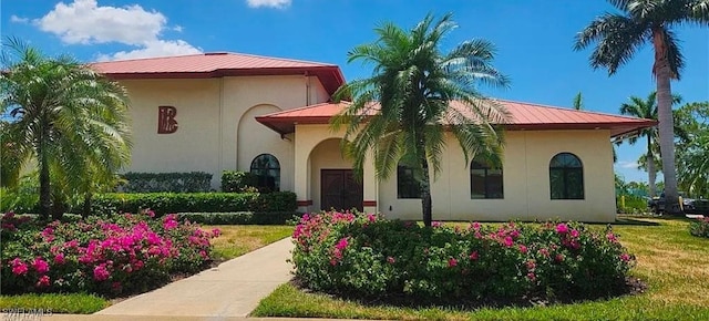 mediterranean / spanish-style home with a front lawn