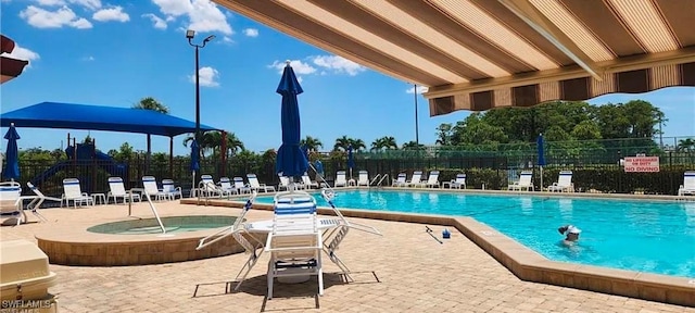 view of pool with a patio area and a community hot tub