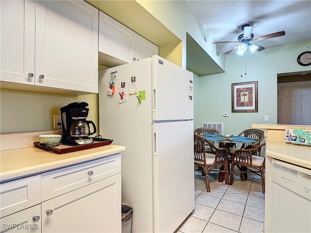 kitchen featuring white cabinetry, white fridge, and light tile patterned floors