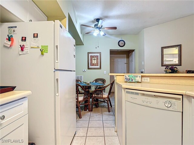 kitchen with light tile patterned floors, white appliances, white cabinetry, and ceiling fan