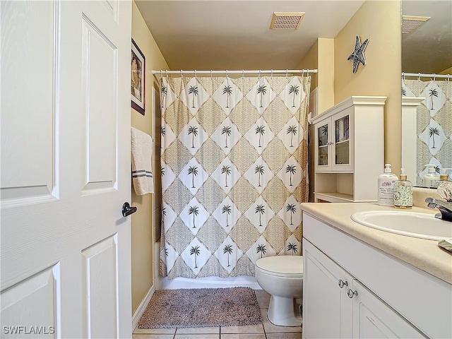 bathroom featuring vanity, tile patterned floors, and toilet