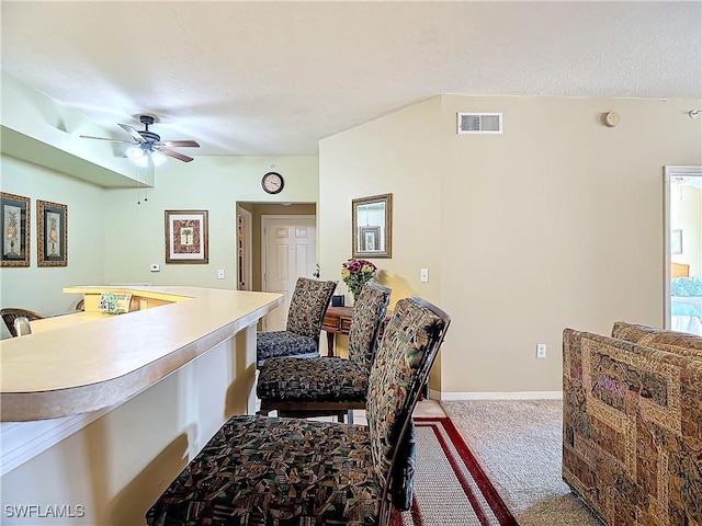 interior space featuring ceiling fan and light carpet