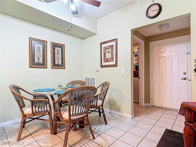 tiled dining room with ceiling fan