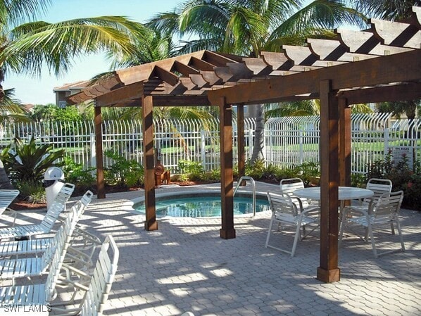 view of swimming pool with a pergola and a patio