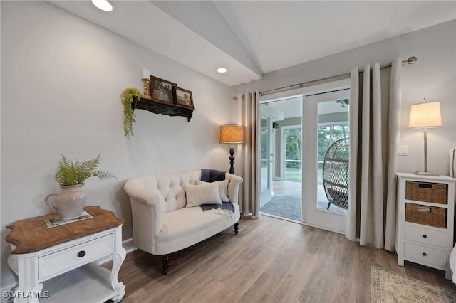 living area with hardwood / wood-style floors and vaulted ceiling