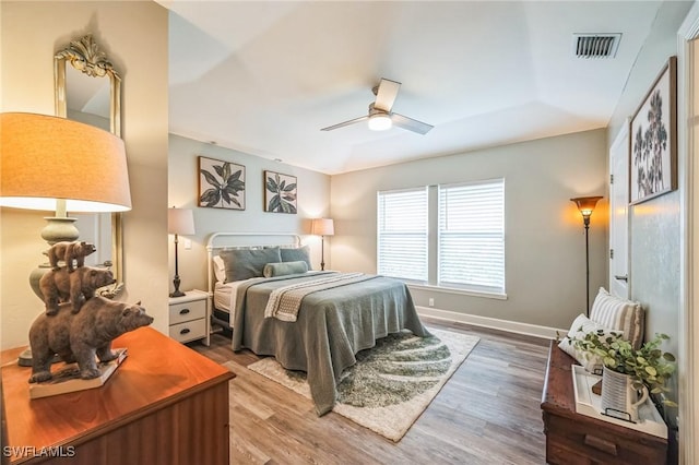 bedroom with hardwood / wood-style floors and ceiling fan