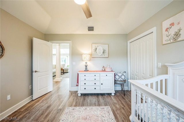 bedroom with ceiling fan, light hardwood / wood-style floors, and a closet