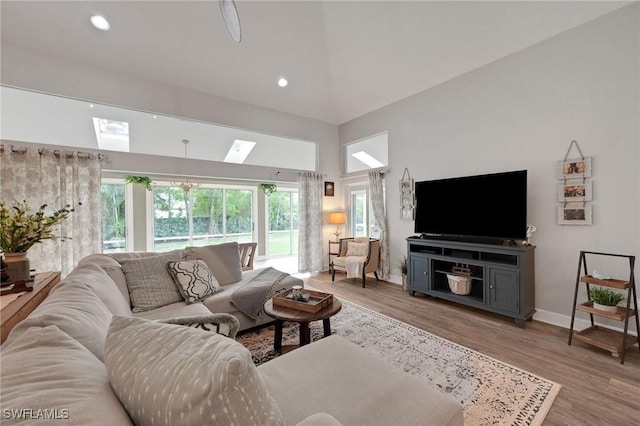 living room featuring hardwood / wood-style flooring and a towering ceiling