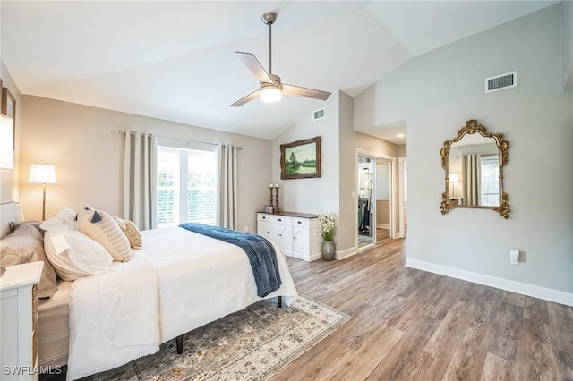 bedroom with hardwood / wood-style flooring, ceiling fan, and vaulted ceiling