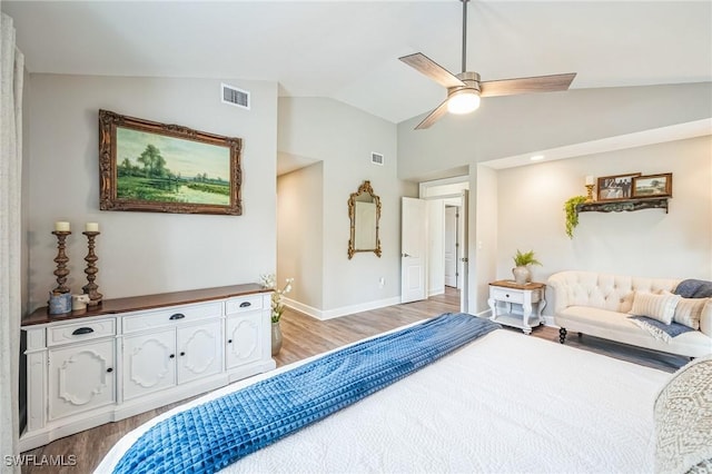 bedroom with ceiling fan, light wood-type flooring, and vaulted ceiling