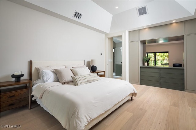 bedroom with recessed lighting, a closet, visible vents, and wood finished floors