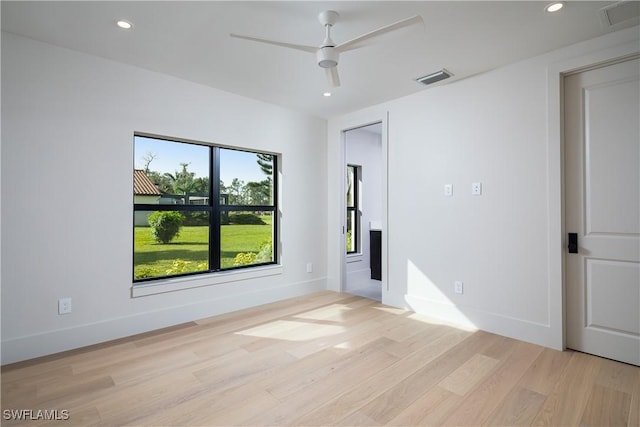 empty room featuring visible vents, baseboards, light wood-style flooring, and recessed lighting