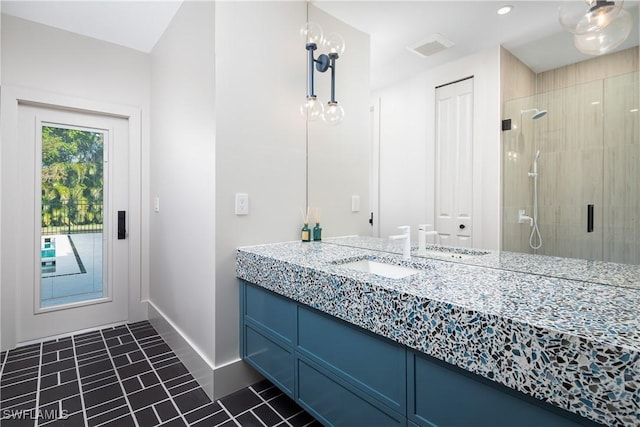 full bathroom with a stall shower, visible vents, baseboards, tile patterned floors, and vanity