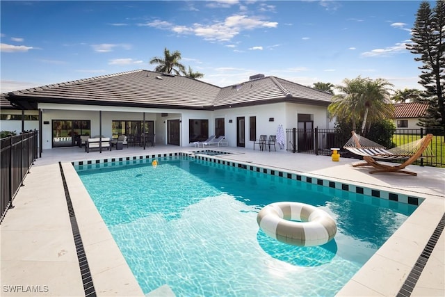 view of swimming pool featuring fence, a fenced in pool, and a patio