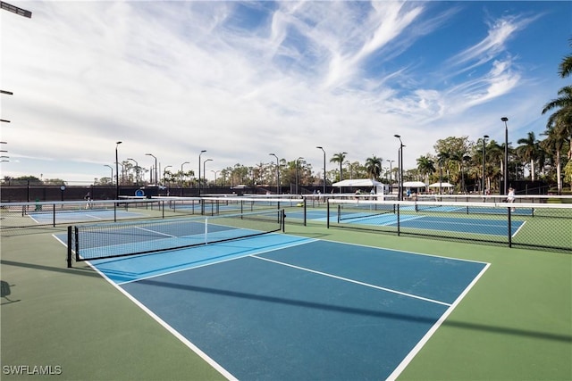 view of tennis court featuring fence