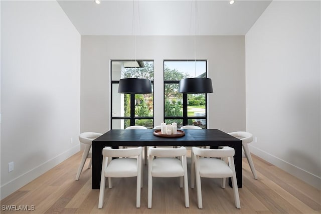 dining space with light wood-type flooring, baseboards, and recessed lighting