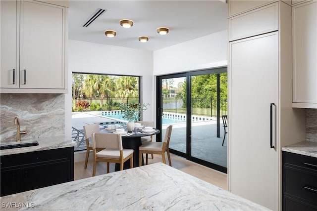 dining room featuring light wood-style floors and visible vents