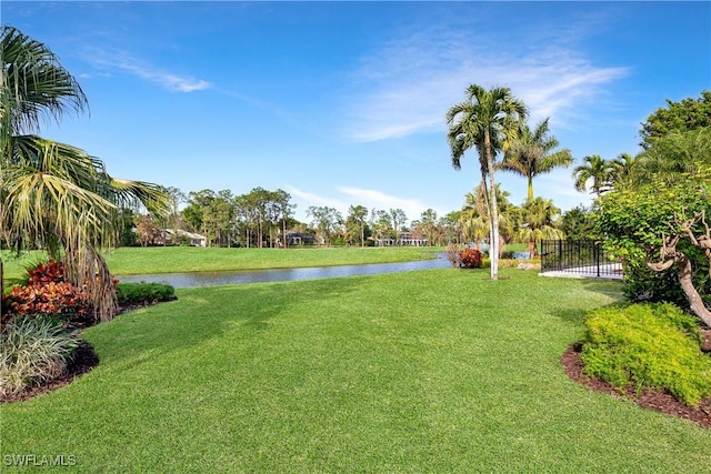 view of yard with a water view and fence