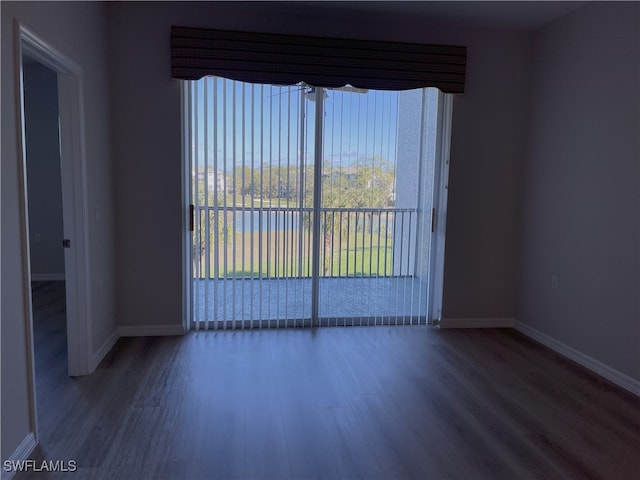 unfurnished room with hardwood / wood-style floors