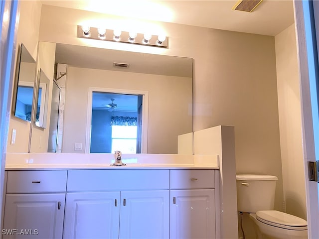 bathroom featuring vanity, ceiling fan, and toilet