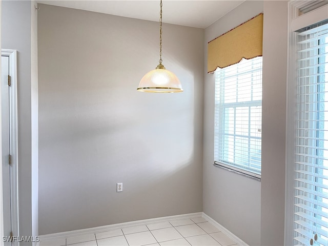 unfurnished dining area with light tile patterned floors and a wealth of natural light