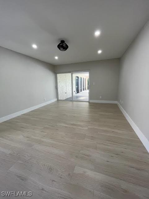 spare room featuring light wood-type flooring