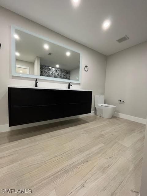 bathroom with hardwood / wood-style floors and vanity