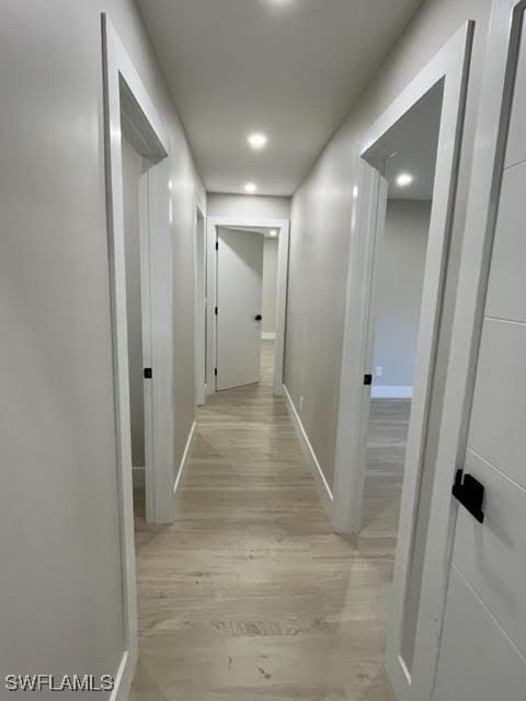 corridor with light hardwood / wood-style floors