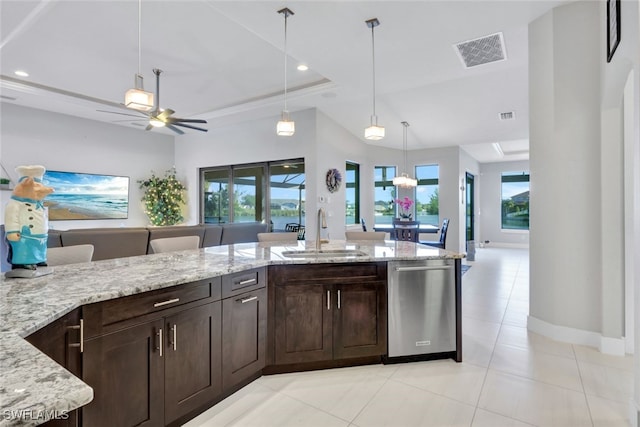 kitchen featuring light stone counters, dark brown cabinets, ceiling fan, sink, and dishwasher