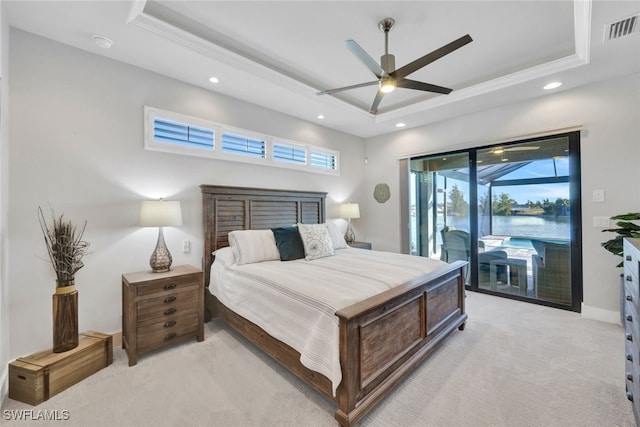 bedroom with light carpet, access to outside, ceiling fan, and a tray ceiling