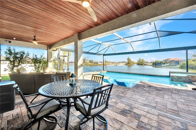 view of patio / terrace with ceiling fan, a swimming pool with hot tub, a water view, and glass enclosure