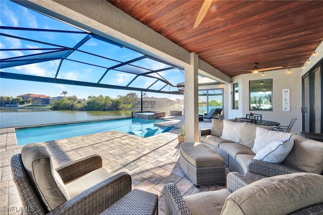 view of patio / terrace with a lanai, an outdoor living space, a swimming pool with hot tub, and a water view