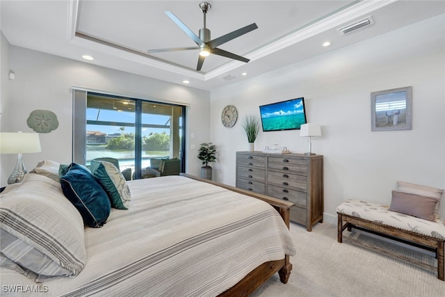 bedroom with ceiling fan, a raised ceiling, crown molding, light colored carpet, and access to outside