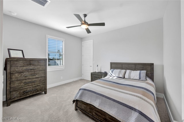 bedroom with ceiling fan and light colored carpet