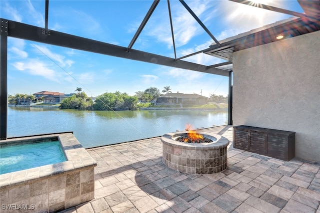 view of patio / terrace featuring a fire pit and a water view