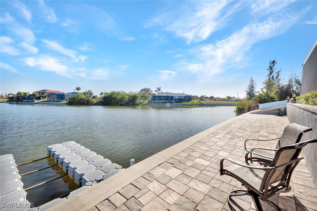 view of patio / terrace featuring a water view and a boat dock