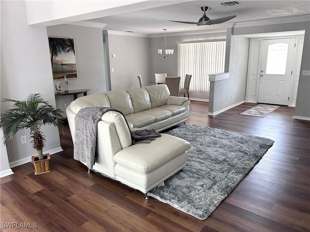 living room featuring ceiling fan with notable chandelier, dark hardwood / wood-style flooring, and crown molding