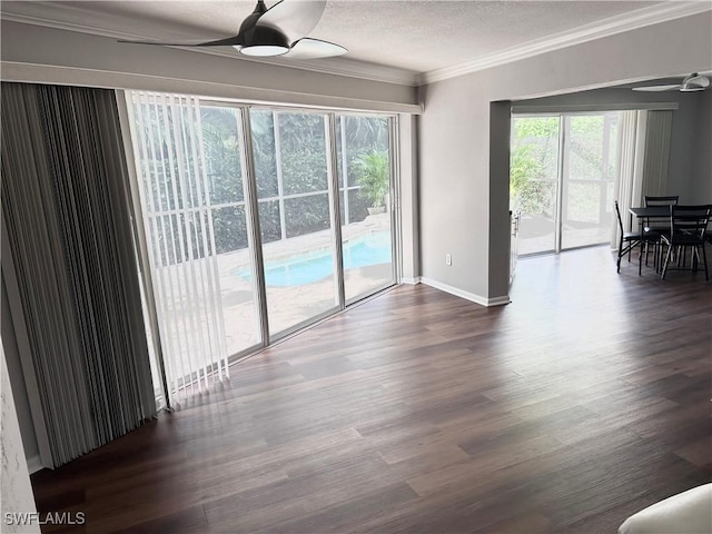 spare room featuring ceiling fan, crown molding, dark hardwood / wood-style floors, and a textured ceiling