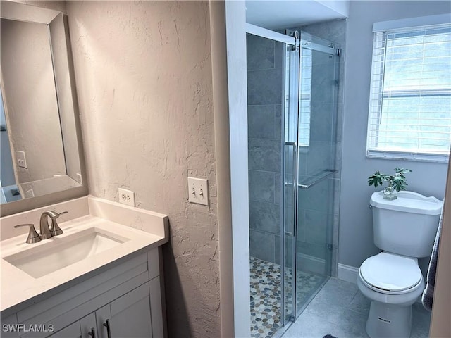 bathroom featuring vanity, toilet, and walk in shower