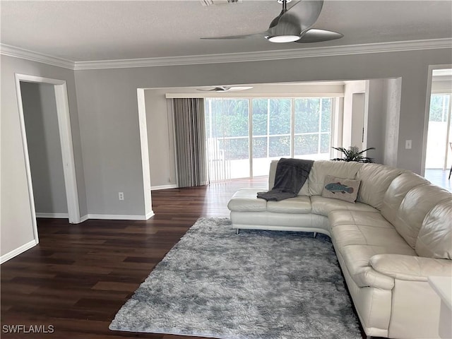 living room featuring a wealth of natural light, crown molding, ceiling fan, and dark wood-type flooring