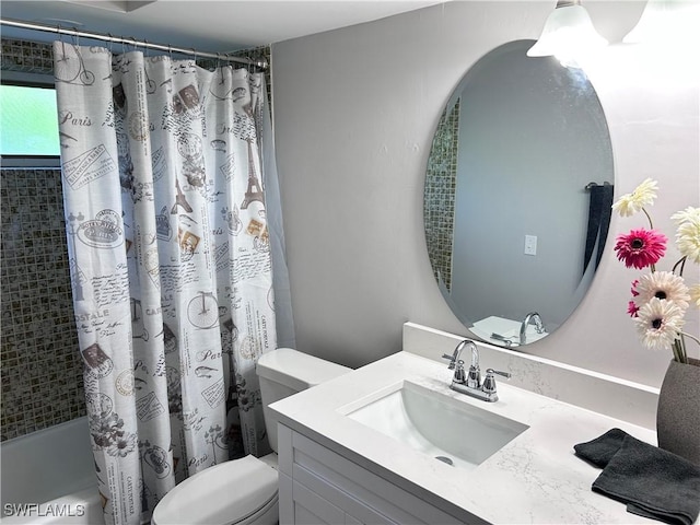 full bathroom featuring shower / bath combo with shower curtain, vanity, and toilet